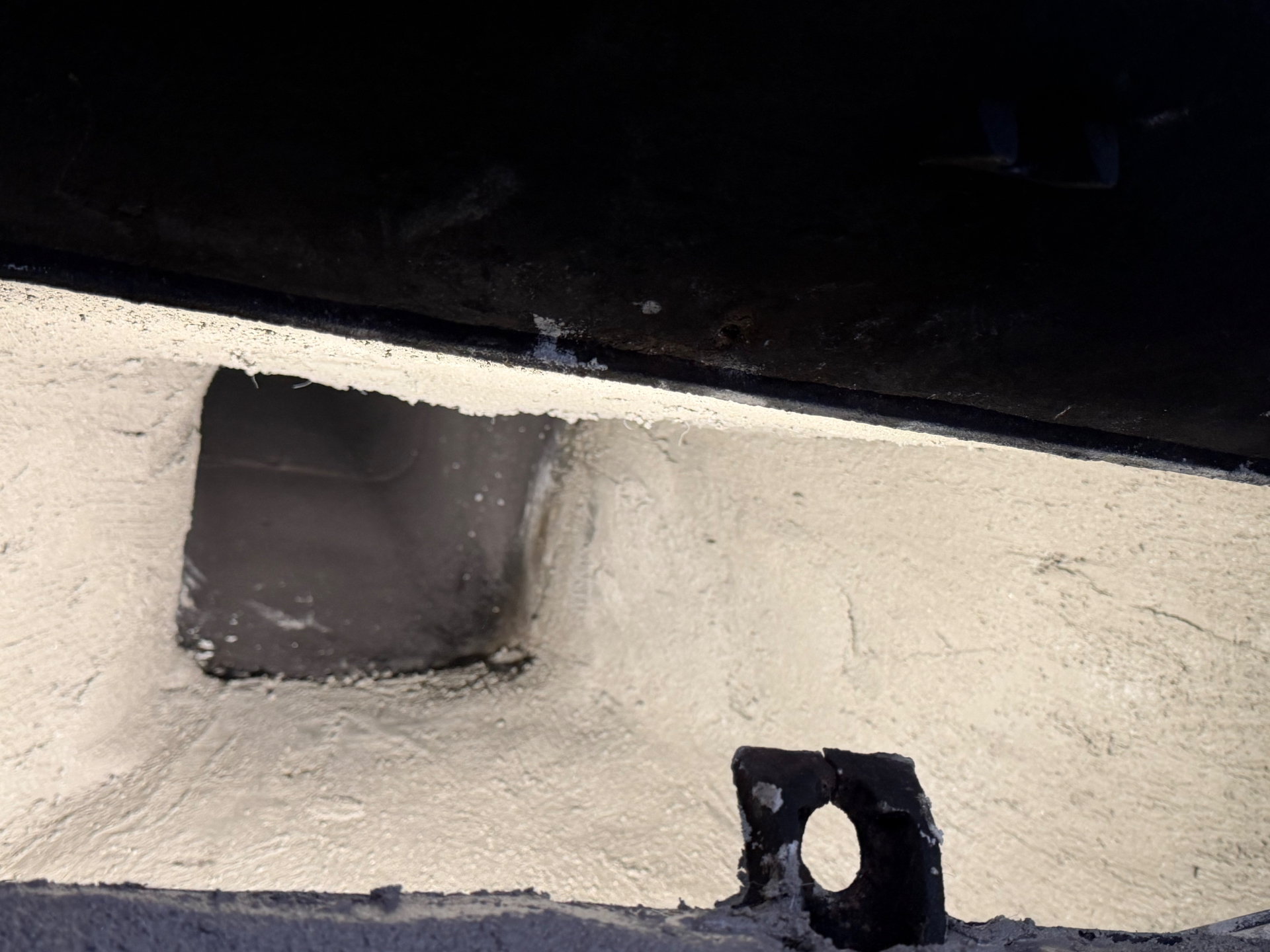 Restored smoke chamber with a smooth Chamber-Tech coating around the flue opening